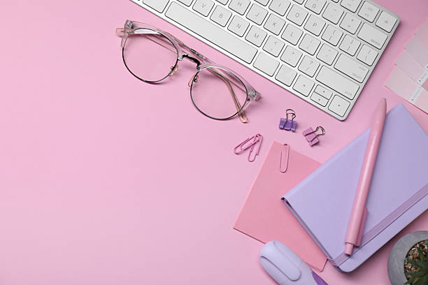 istock Designer's workplace with keyboard and stationery on pink background, flat lay. Space for text 2213672731