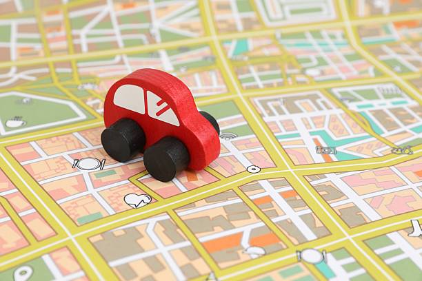 istock Red toy car on city map. Road trip 2213672915