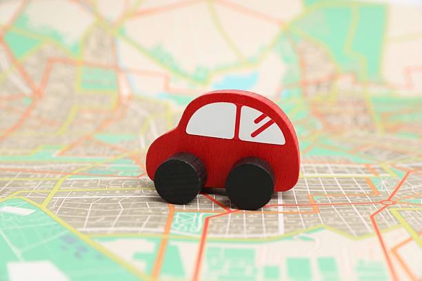 istock Red toy car on city map. Road trip 2213672917