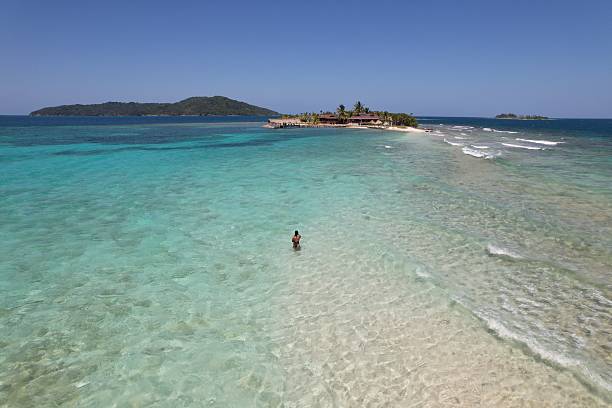 istock Tropical island with clear turquoise waters and bright sky. 2213672929