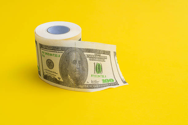 A torn piece of a U.S. one-hundred-dollar bill, focusing on a close-up of Benjamin Franklin’s mouth and chin. Concept of financial disruption, economy, and the fragility of money, physical currency.
