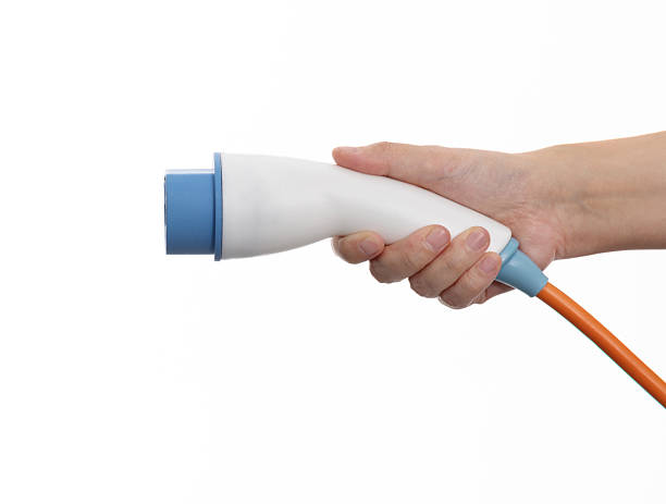 istock Human hand holding electric plug on white background 2213674057