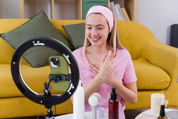 istock Young Adult Woman Filming Beauty Tutorial at Home 2213677770