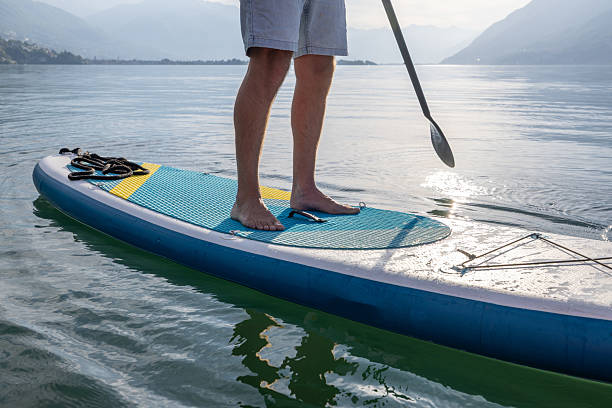 istock Man Paddleboarding on Calm Mountain Lake 2213678779