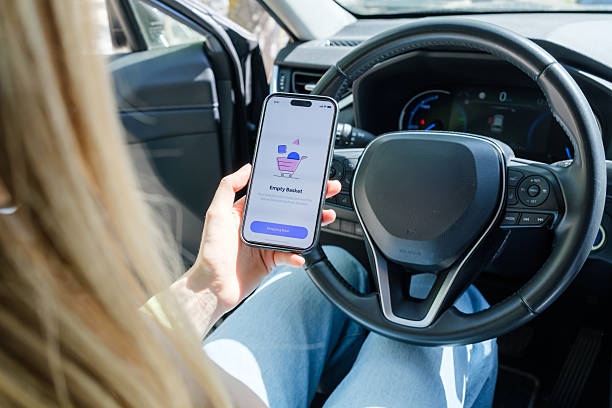 istock Young Adult Using Smartphone in Car Interior 2213679112