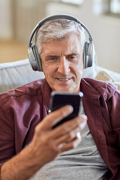 istock Mature male using mobile phone at home 2213680016
