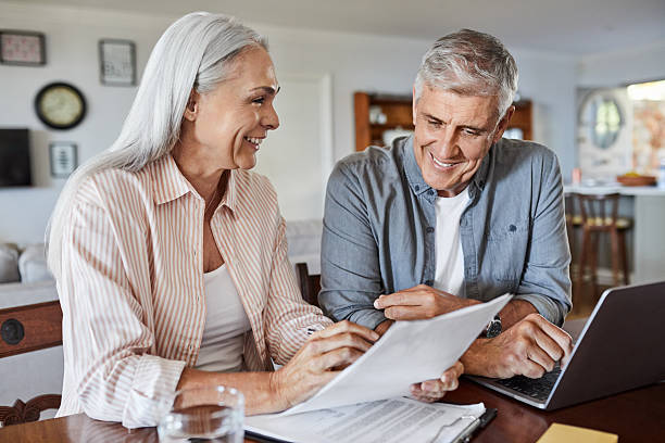 istock Smiling couple planning budget 2213680044