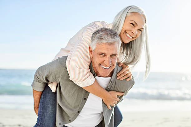 istock Happy mature couple at beach during vacation 2213680116