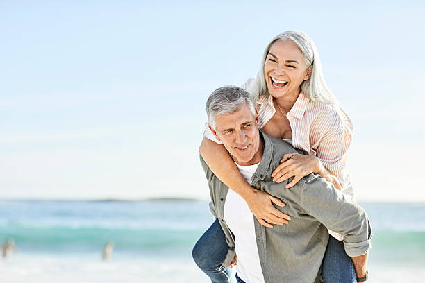 istock Happy couple enjoying at beach during vacation 2213680117