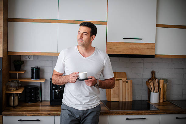 istock Man enjoying fresh aromatic coffee in kitchen 2213680816