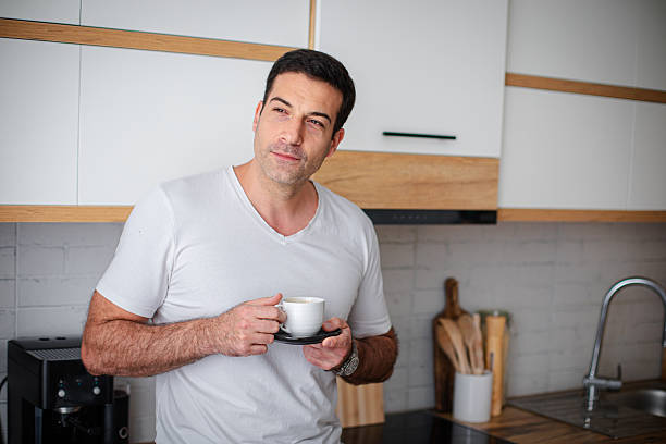 istock Man enjoying fresh aromatic coffee in kitchen 2213680831
