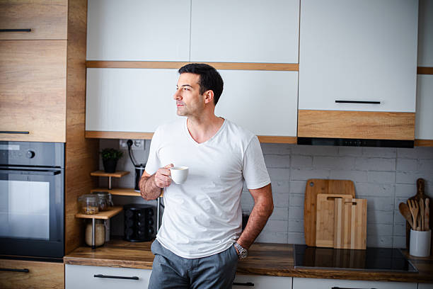 istock Man enjoying fresh aromatic coffee in kitchen 2213680914