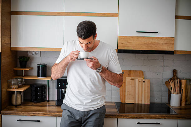 istock Man enjoying fresh aromatic coffee in kitchen 2213681096