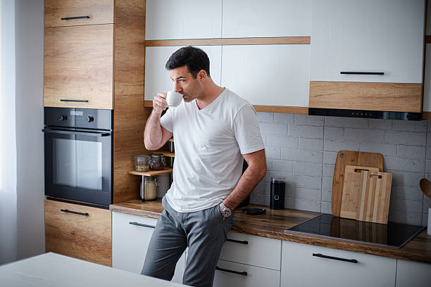 istock Man standing alone in kitchen, drinking coffee and enjoying in his morning routine 2213681441