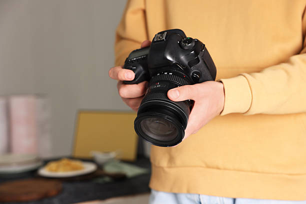 istock Photographer with professional camera in studio, closeup. Space for text 2213682256