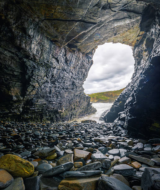 Coastal cave full of wave polished boulders under a cliff in Ribadeo Lugo Galicia