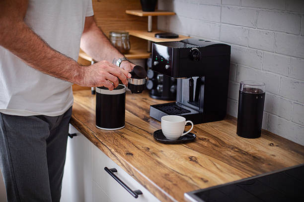 istock Man making coffee in his domestic kitchen, close up 2213685776