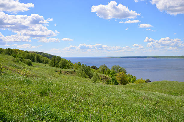 istock A serene view of a green landscape with a river under a blue sky 2213688371