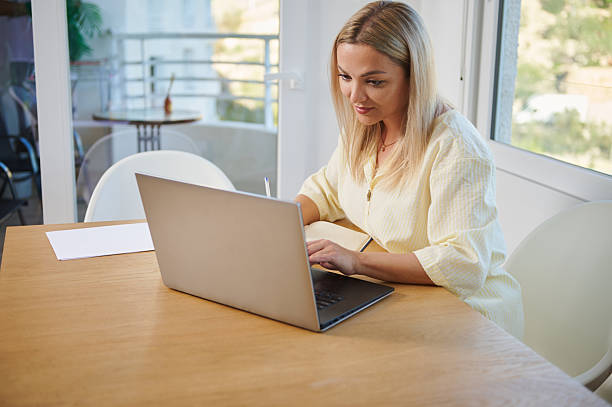 istock Professional Woman Working on Laptop in Bright and Comfortable Office Space 2213690155