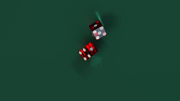 istock Two red dice fall onto a green table for casino craps game 2213691580