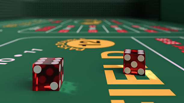 istock Two red dice are on a green table for casino craps game 2213691583