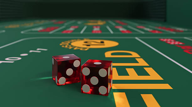 istock Two red dice are on a green table for casino craps game 2213691593