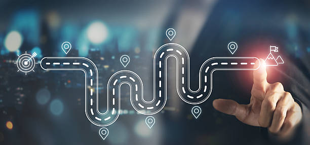 istock Business and Project Roadmap Concept. Touching on virtual screen with roadmap overlay representing steps in a project or strategic planning process. Waypoint icons and ends with goal achievement. 2213692025