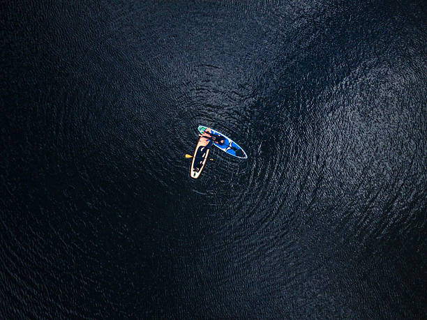 istock Aerial View of paddleboarders Exploring Serene Lake Waters 2213692084