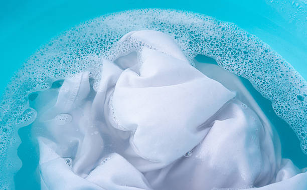 istock Hand laundry washing clothes in blue plastic basin 2213693444