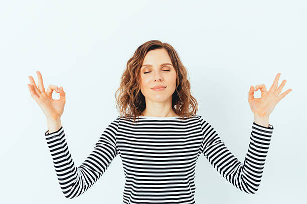 istock A woman is meditating with her hands in a prayer position 2213694915