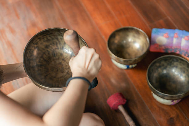 Spiritual healing sound bath therapy involves crystal bowls, gongs, and chimes that create harmonic frequencies, resonating with the body, mind, and soul. These sounds encourage deep relaxation, the release of negative energy, and a profound sense of inner peace