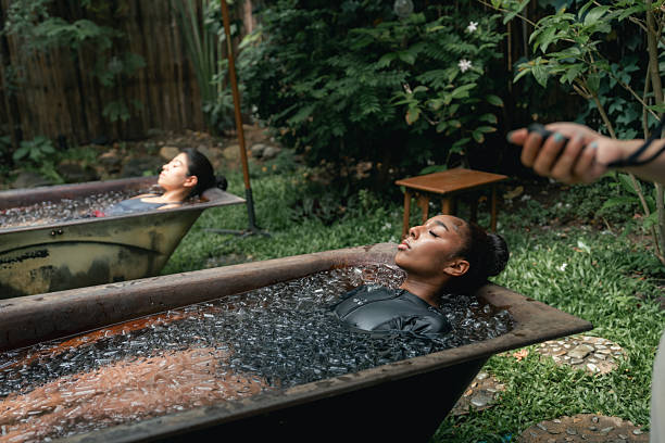 istock Women practicing necessary steps for ice bath therapy, pinching their noses with their fingers to hold their breath 2213698343
