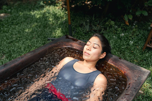 istock Women practicing necessary steps for ice bath therapy, pinching their noses with their fingers to hold their breath 2213698383