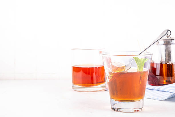 Black tea trendy asian dessert, diet non calorie sweet tea agar or gelatine jelly, in portioned glass, white table background copy space