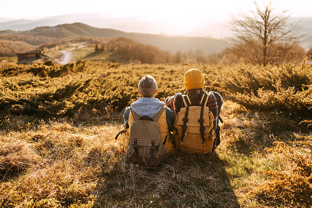 istock Couple sitting side by side, enjoying sunset 2213700812