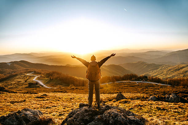 istock Back view woman with arms wide open in mountain sunset 2213700966
