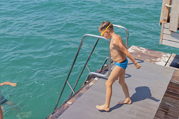 Little girl and her father swimming in the sea