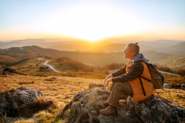 istock Female hiker sitting on rock during mountain adventure 2213701317