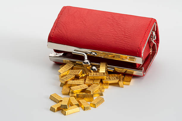 Shiny gold nugget on wet stone, closeup. Space for text