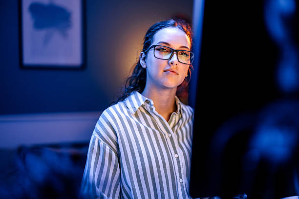 istock Beautiful woman using desktop computer in home office at night 2213704930