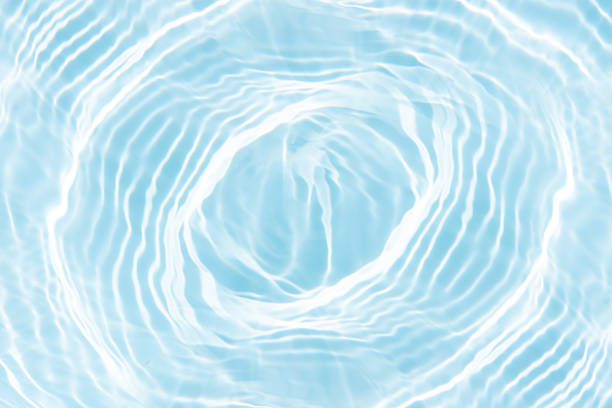 istock Blue water with ripples on the surface. Defocus blurred transparent blue colored clear calm water surface texture with splashes and bubbles. Water waves with shining pattern texture background. 2213705077
