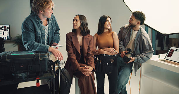 istock Conversation, photography and planning with people in studio together for discussion, photoshoot or review. Backstage, camera or tablet with makeup artist, model and photographer talking on set 2213705225