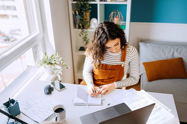 istock Young woman studying at home with concentration 2213705560