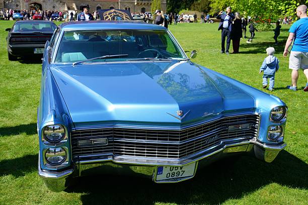 sychrov, Czech Republic – April 26, 2025: A classic blue Cadillac car parked on green grass outdoors