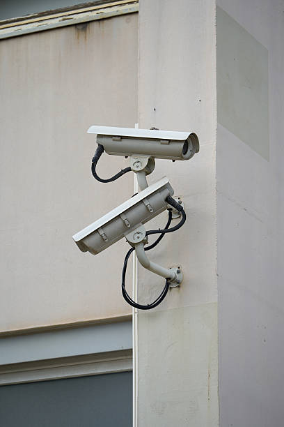 istock Two outdoor surveillance cameras on the wall, security system. 2213713907