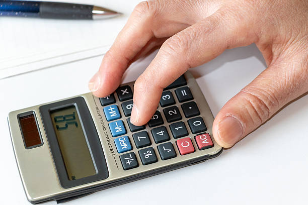 istock Tap the calculator keys with a finger 2213715481