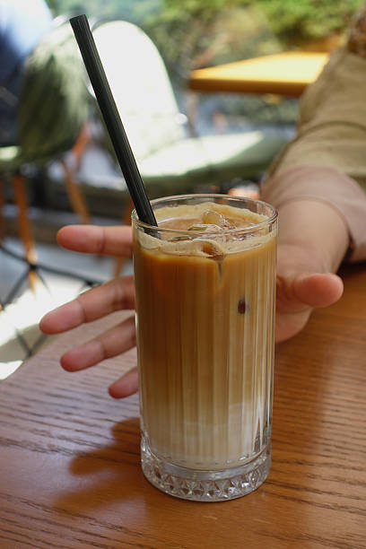 istock iced late in a transparent glass on cafe table 2213716748