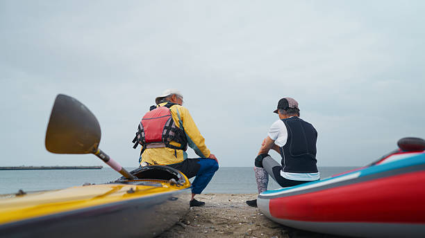 istock Two senior men chatting with each other at the beach 2213722472