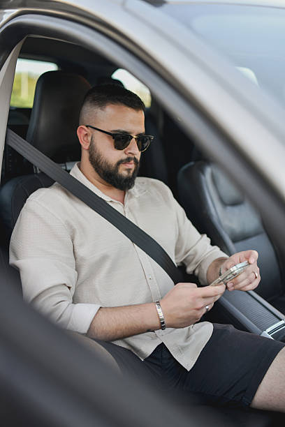 istock Calm Male Texting on His Phone While Waiting in the Passenger’s Seat 2213728204