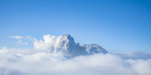 istock Scenic Mountain Peak Above the Clouds under Clear Blue Sky 2213732460